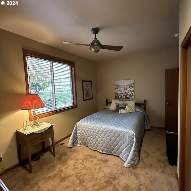 bedroom featuring ceiling fan and carpet