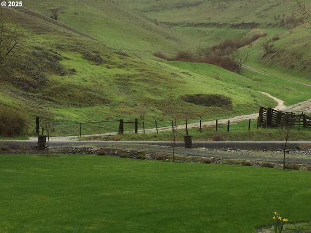 view of community featuring a lawn and a rural view