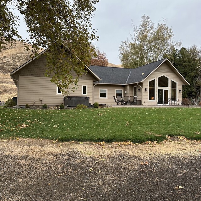 81890 S Fork Walla Walla Riv Rd, Milton-Freewater, OR 97862 - rear view of property featuring a hot tub, a patio, and a lawn