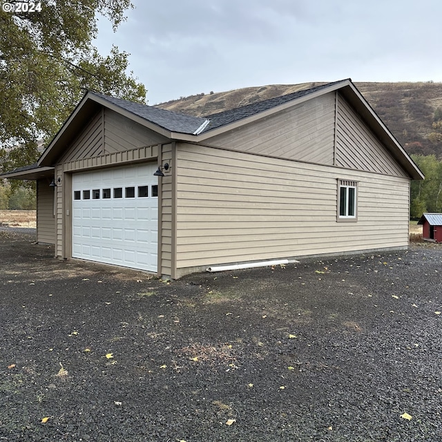 81890 S Fork Walla Walla Riv Rd, Milton-Freewater, OR 97862 - view of side of home featuring an attached garage, asphalt driveway, and roof with shingles