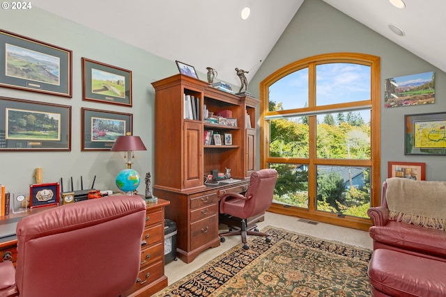 carpeted home office featuring vaulted ceiling