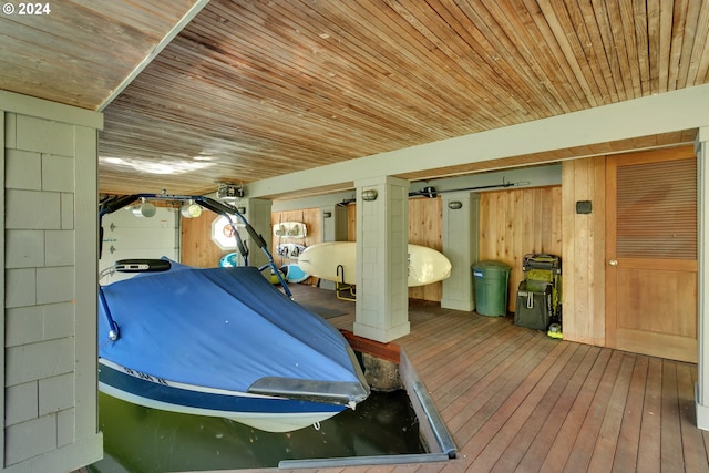 bedroom featuring wood walls, wood-type flooring, and wooden ceiling