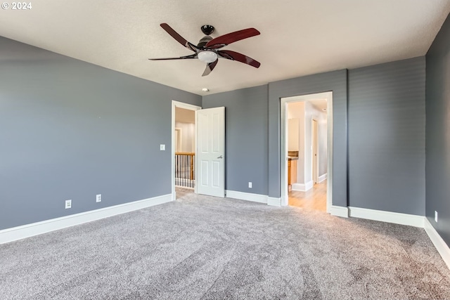 unfurnished bedroom featuring light carpet and ceiling fan