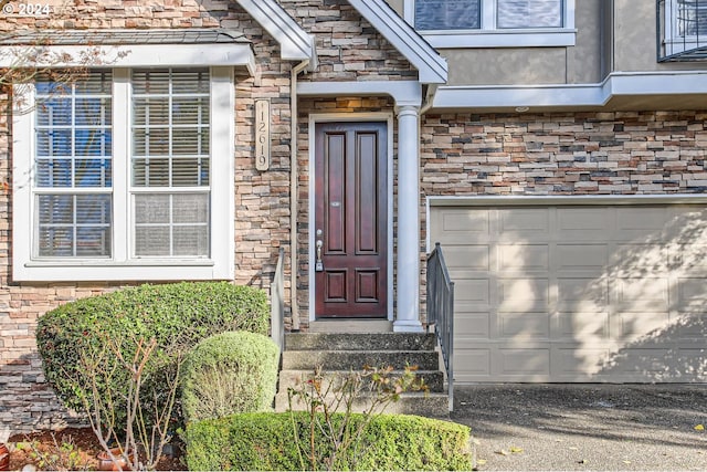 view of exterior entry with a garage