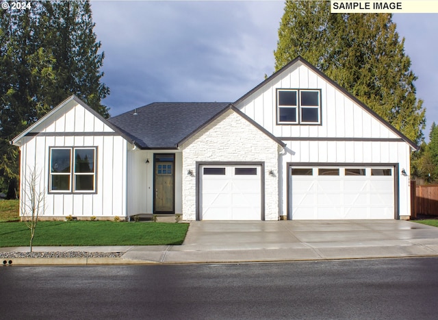 view of front of house with a garage and a front lawn