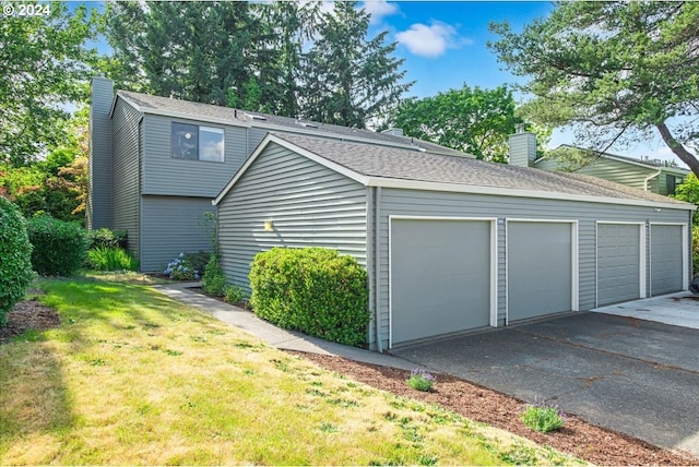 garage featuring a lawn