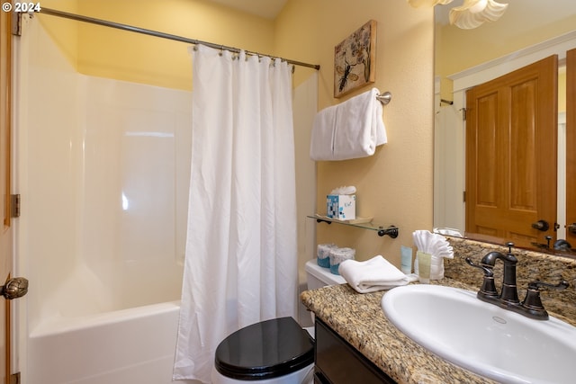 full bathroom featuring vanity, shower / bath combo, and toilet