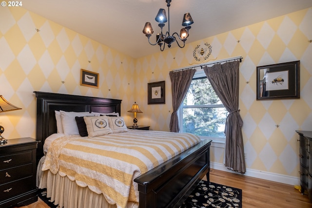 bedroom featuring light hardwood / wood-style flooring and a notable chandelier