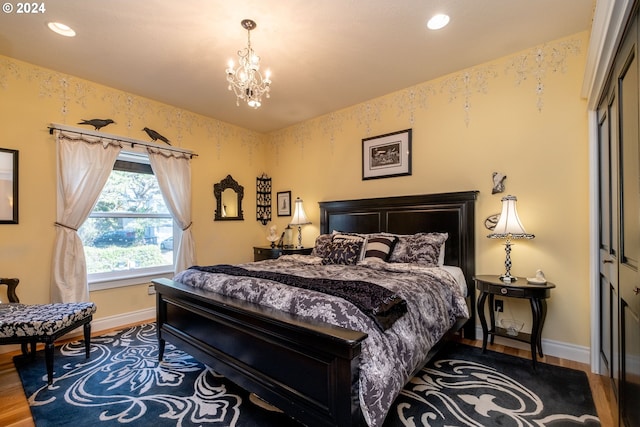 bedroom featuring a chandelier, wood-type flooring, and a closet