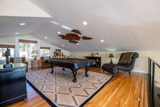 game room with wood-type flooring, a textured ceiling, pool table, and vaulted ceiling