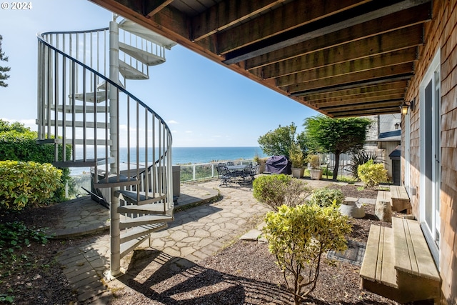 view of patio featuring a water view