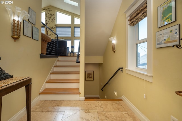 staircase featuring vaulted ceiling