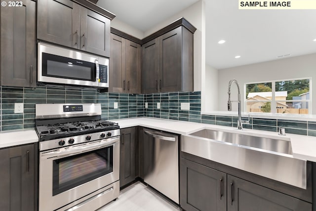 kitchen with tasteful backsplash, appliances with stainless steel finishes, sink, and dark brown cabinets