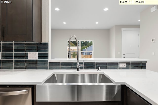 kitchen with dark brown cabinetry, sink, dishwasher, light stone countertops, and decorative backsplash