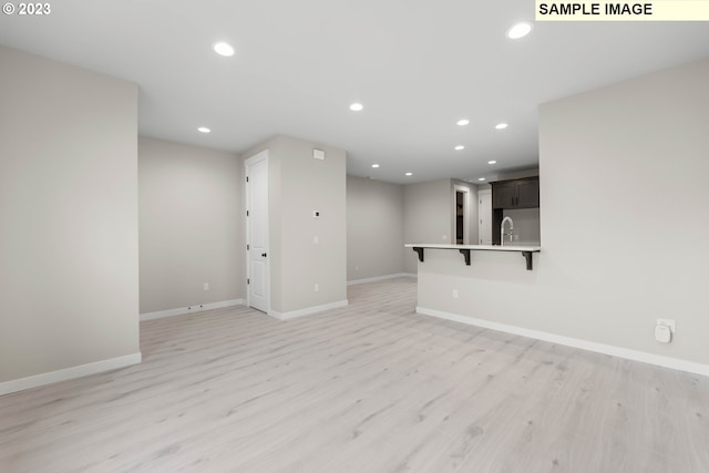 unfurnished living room featuring light wood-type flooring