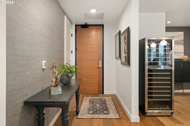 590 Waterfront Way Unit 202, Vancouver, WA 98660 - entryway featuring baseboards, wine cooler, wood finished floors, and an accent wall