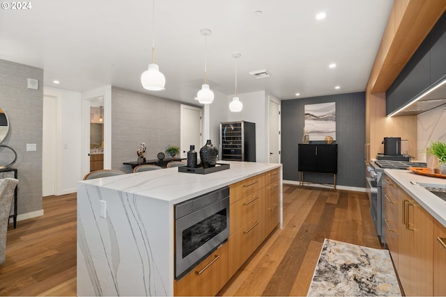 590 Waterfront Way Unit 202, Vancouver, WA 98660 - kitchen with light wood-type flooring, stainless steel appliances, modern cabinets, and a kitchen island