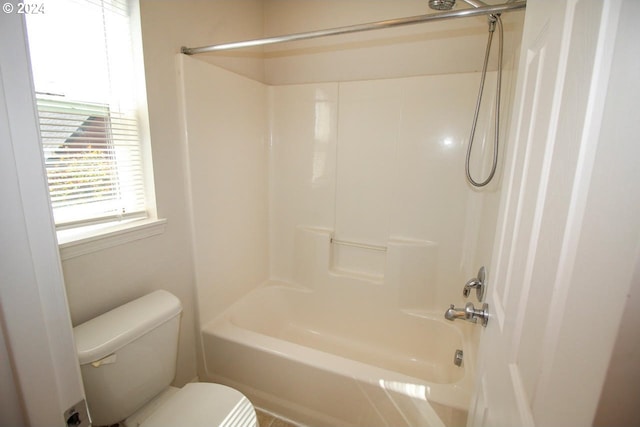 bathroom with toilet and  shower combination