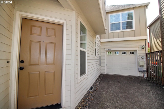 view of exterior entry featuring a garage