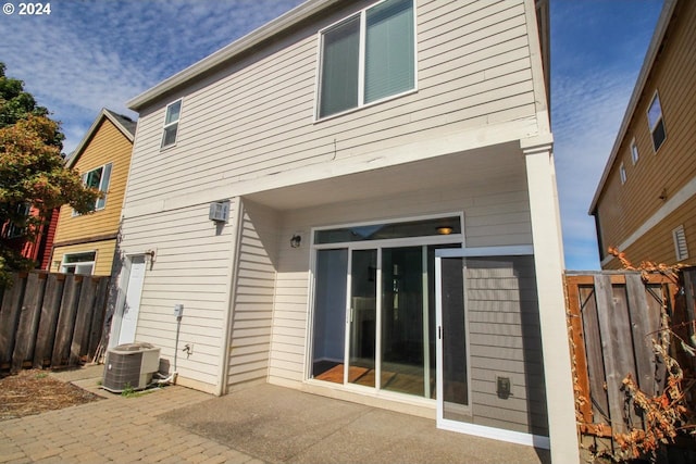 rear view of house featuring a patio area and central AC