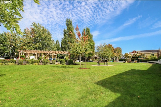 view of community with a lawn and a pergola