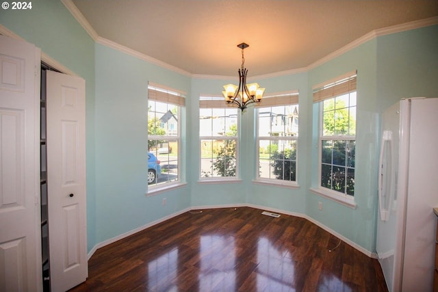 unfurnished dining area featuring crown molding, dark hardwood / wood-style floors, and a notable chandelier