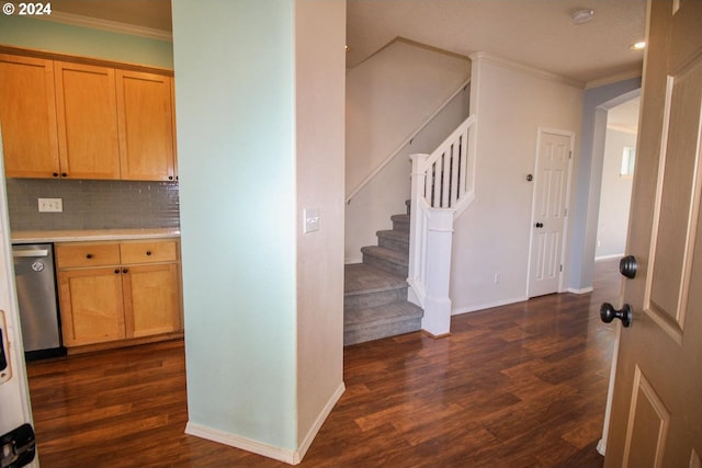 interior space with tasteful backsplash, dark hardwood / wood-style floors, crown molding, and stainless steel dishwasher