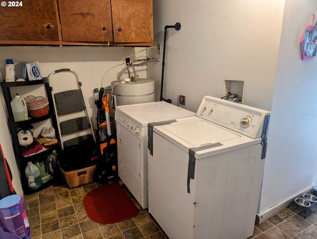 clothes washing area with cabinets and washing machine and clothes dryer