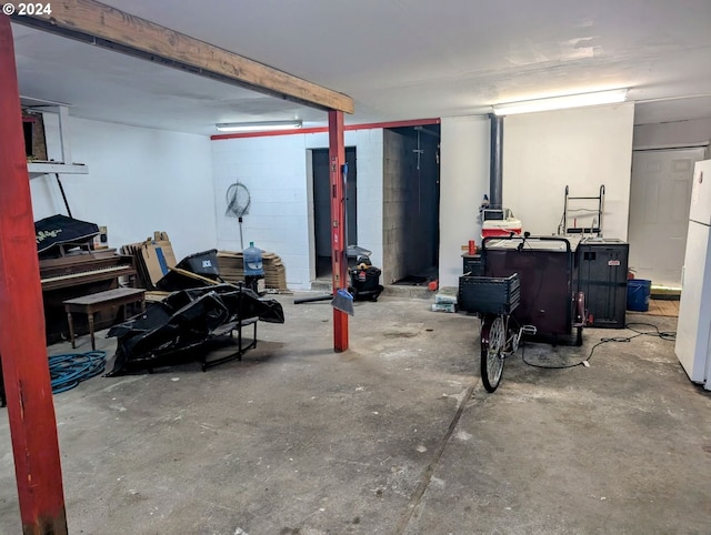 basement with white refrigerator