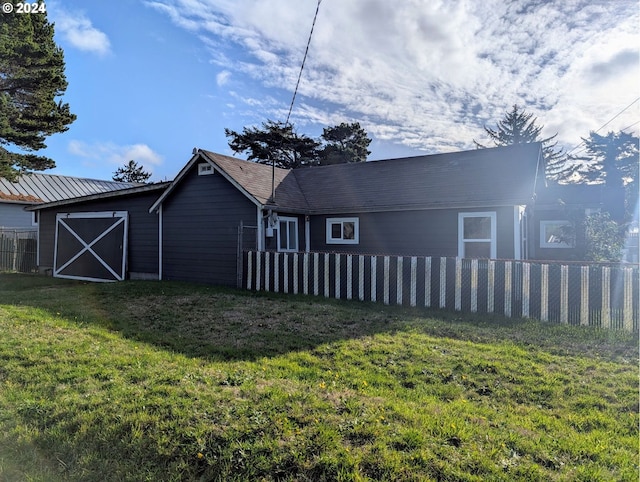 back of house with a lawn