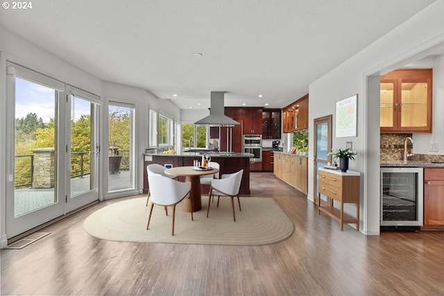 dining room with wine cooler, sink, and dark hardwood / wood-style floors