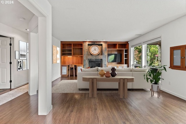 living room with dark wood-type flooring and a fireplace