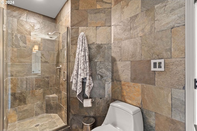 bathroom featuring toilet, an enclosed shower, and tile walls