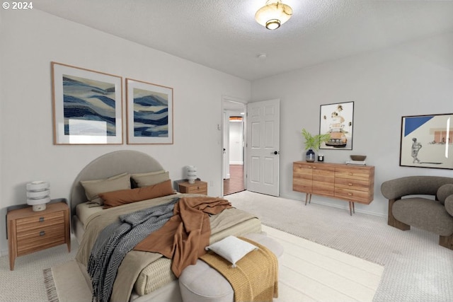 bedroom with a textured ceiling and carpet floors