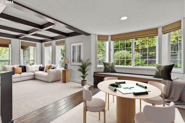 sunroom / solarium featuring beam ceiling, a healthy amount of sunlight, and coffered ceiling