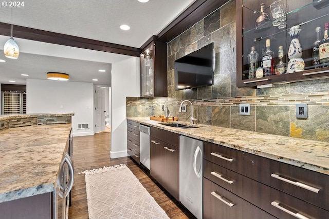 kitchen featuring stainless steel dishwasher, sink, decorative light fixtures, and dark hardwood / wood-style flooring