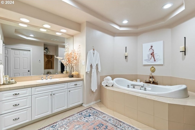 bathroom with vanity, tiled bath, and tile patterned flooring