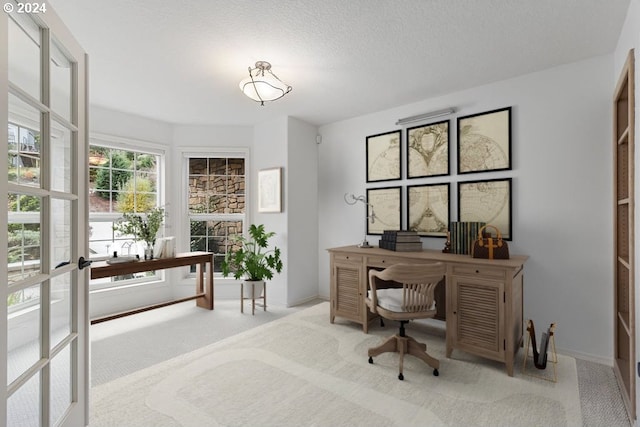 office area with light carpet and a textured ceiling