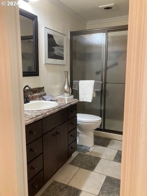 bathroom featuring vanity, toilet, an enclosed shower, and crown molding