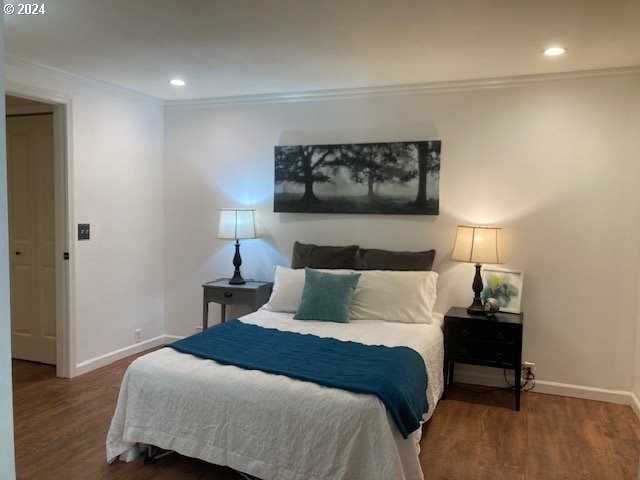 bedroom featuring dark hardwood / wood-style flooring and ornamental molding