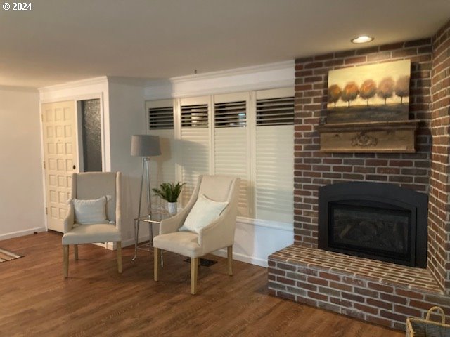 living area featuring a fireplace and wood-type flooring