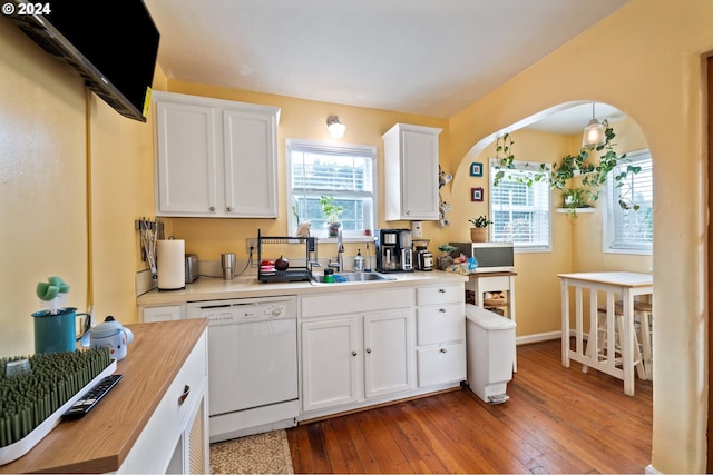 kitchen with white appliances, sink, wood-type flooring, white cabinets, and butcher block countertops