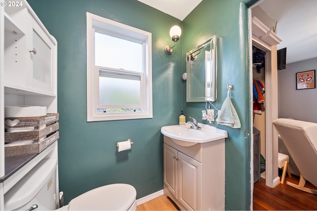 bathroom with vanity, wood-type flooring, and toilet