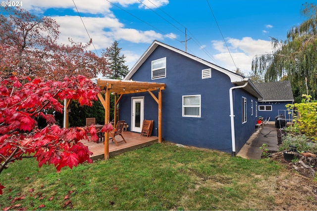 back of house featuring a pergola, a yard, and a deck