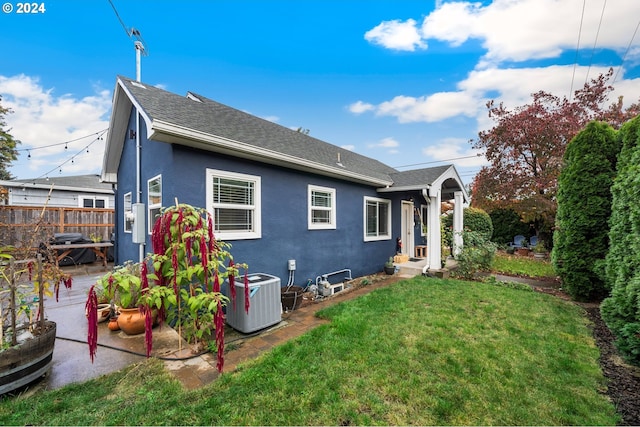 back of house with a yard, central AC, and a patio area