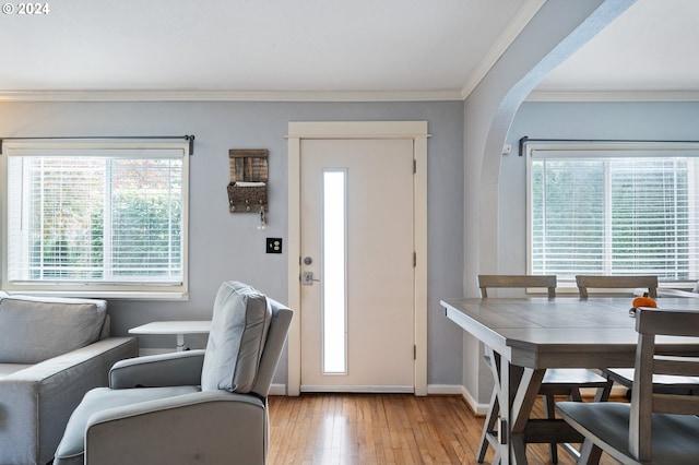 entryway featuring light hardwood / wood-style floors and ornamental molding