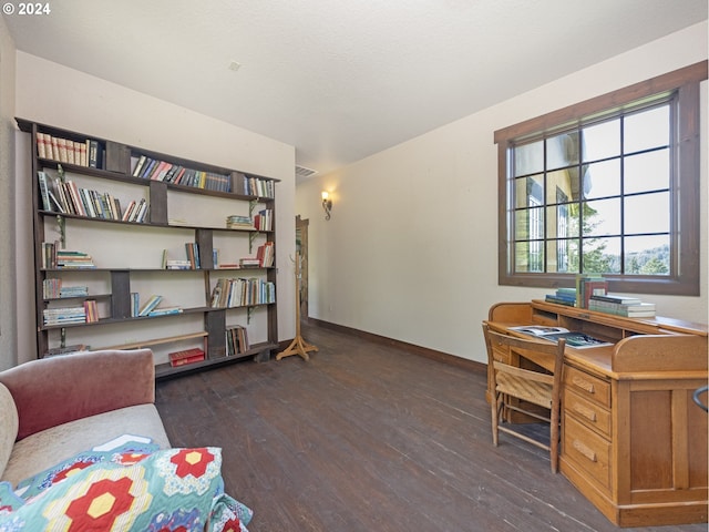 home office with dark hardwood / wood-style floors