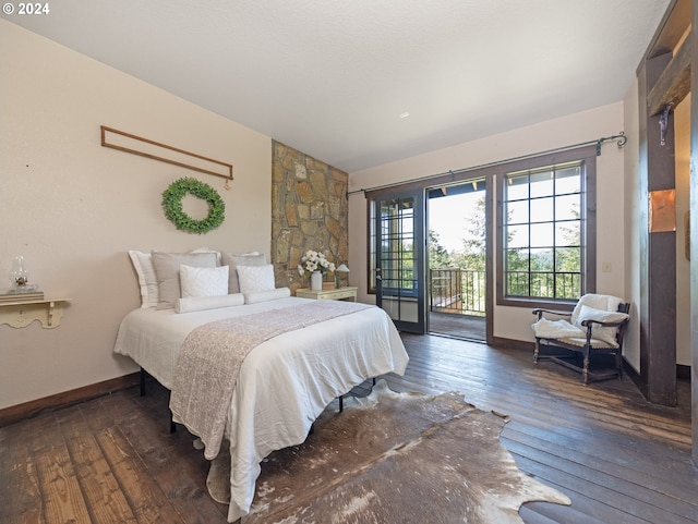 bedroom with dark hardwood / wood-style flooring and access to exterior