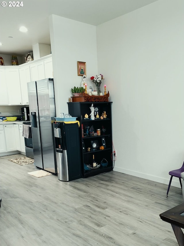 kitchen featuring appliances with stainless steel finishes, light wood-type flooring, and white cabinets