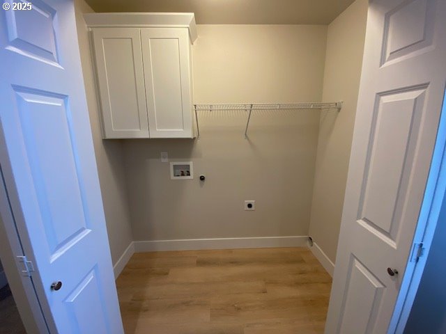 washroom with light wood finished floors, cabinet space, baseboards, washer hookup, and electric dryer hookup